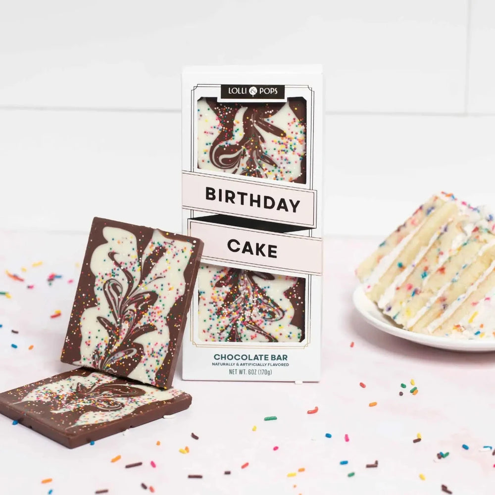 6 oz Birthday Cake Topp’d Bar by Lolli and Pops next to a piece of Birthday cake.