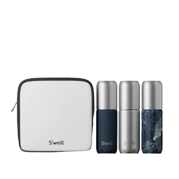 Azurite Travel Bottle Set featuring three bottles in marble, silver, and navy, displayed with a recycled plastic toiletry bag.