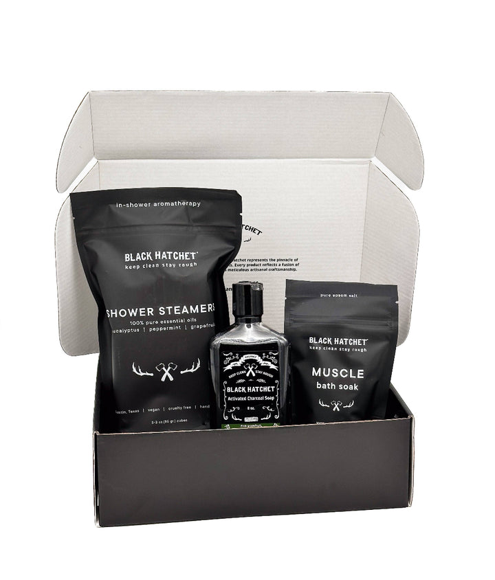 Black Hatchet Gift Set for Men, featuring body wash, shower steamers, and muscle soak, elegantly packaged.