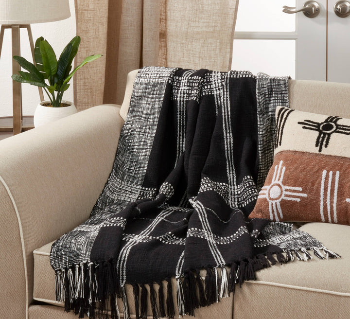 Black and White Plaid Throw Blanket draped over a sofa with pillows.