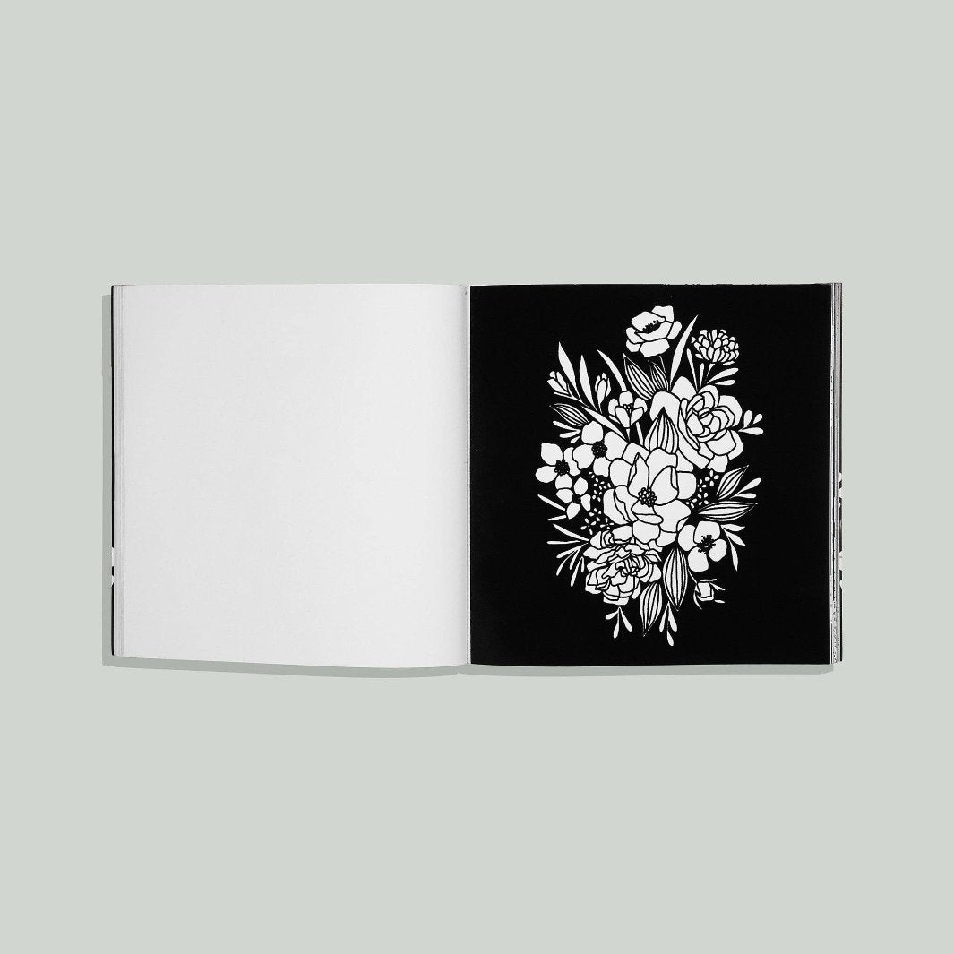 A black velvet page with a floral outline for a unique coloring experience.