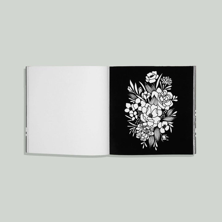 A black velvet page with a floral outline for a unique coloring experience.
