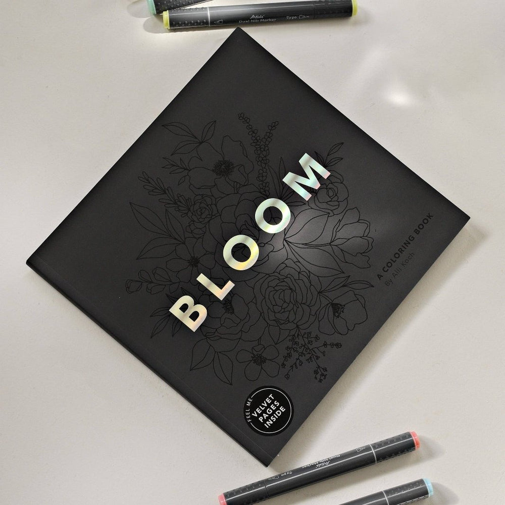 Bloom Adult Coloring Book on a Table with Markers
