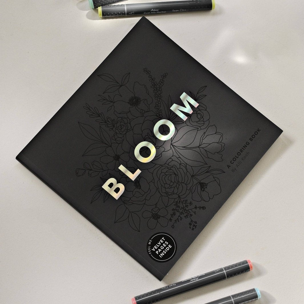 Bloom Adult Coloring Book on a Table with Markers
