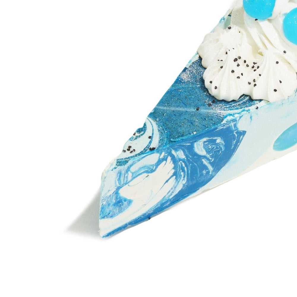 Close up of Blueberry Swirl Cake Soap slice, showcasing realistic bakery-inspired details.