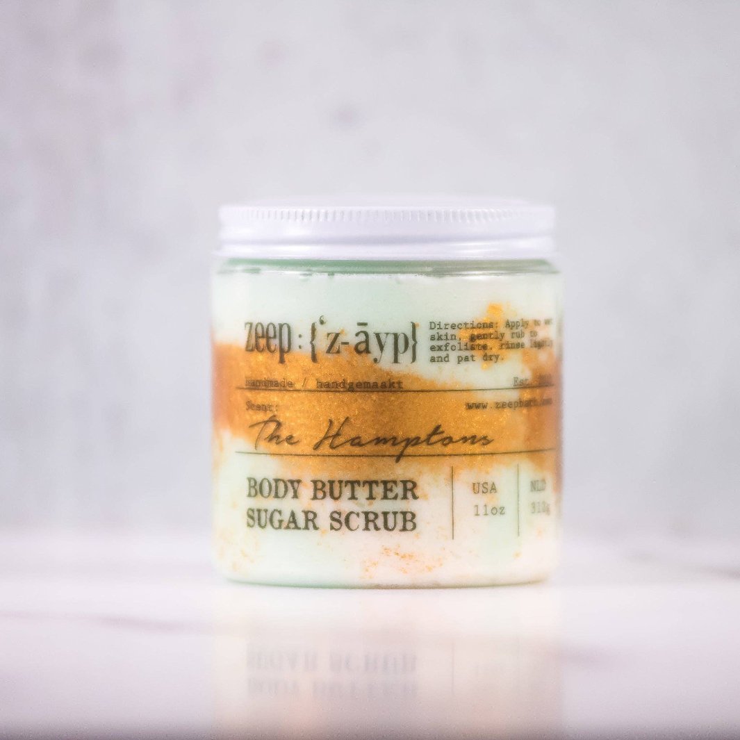 Close-up view of the whipped sugar scrub texture, showcasing the creamy, emulsified blend of sugar, oils, and butters for silky smooth skin.