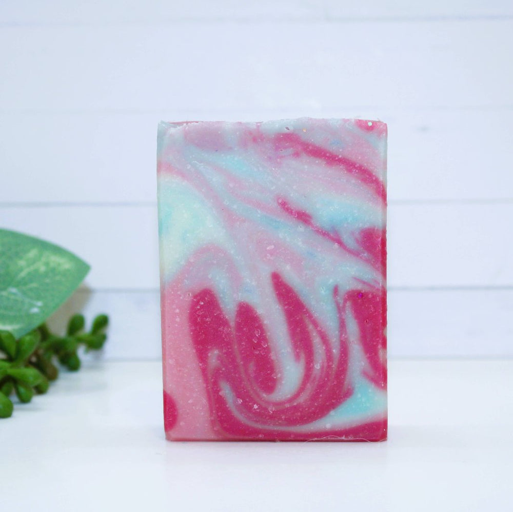 Close-up of Mermaid Cove Soap Bar showcasing vibrant pink and blue swirls with shimmering biodegradable glitter accents.