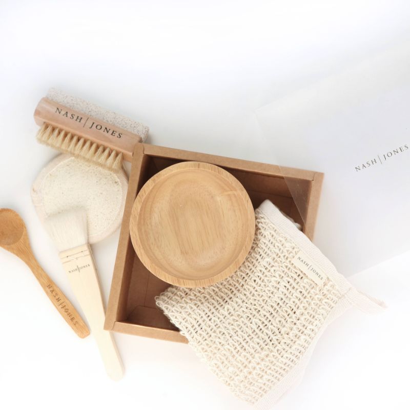 Exfoliate Gift Set by Nash & Jones, featuring Agave Cloth, Lava & Boar, Loofah Veggie Scrub, Bamboo Mask Mixing Spoon, Bamboo Mask Bowl, and Goat Hair Hake Mask Application Brush. Perfect for a thorough and gentle exfoliation.