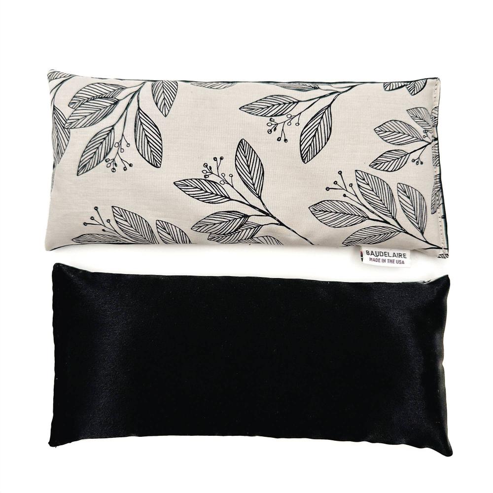 Floral Laurel Eye Pillow by Baudelaire- weighted, blend of 100% cotton and cooling silk, filled with French lavender and flax seeds. Black and white cotton print on front, black cooling silk on back. 