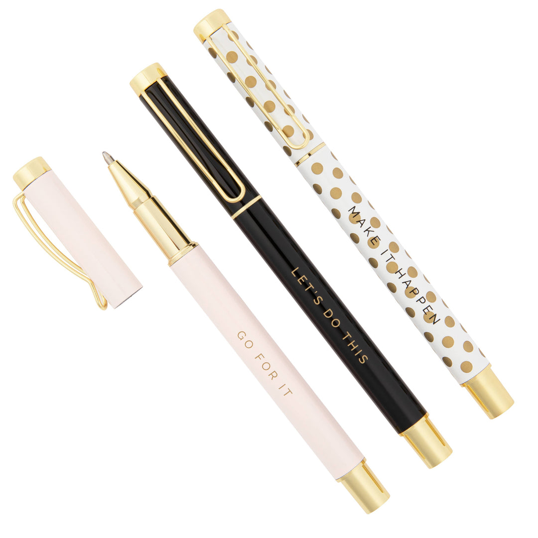 Set of three stylish motivational pens in light pink, black, and white with gold dots.