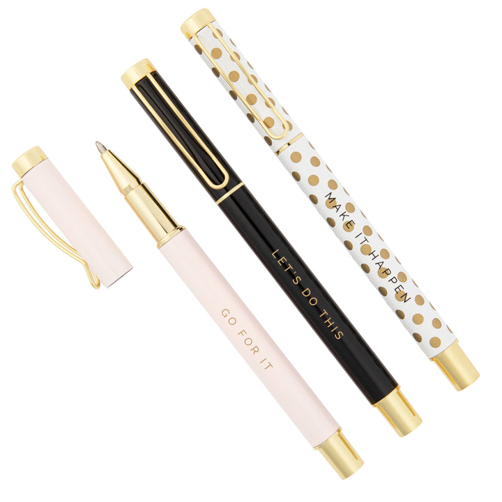 Set of three stylish motivational pens in light pink, black, and white with gold dots.
