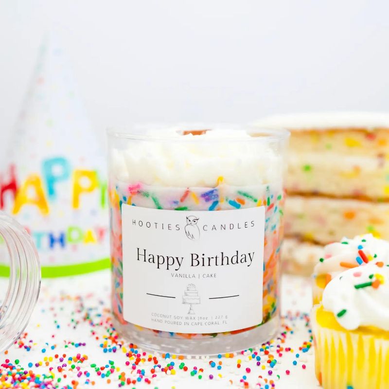 Birthday Cake Candle: Soy candle with a crackling wood wick, in a jar labeled "Birthday Celebration," with a scent of Vanilla Buttercream and Vanilla Cake.