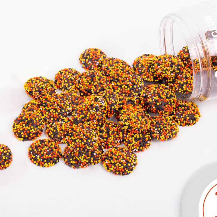 Close-up of Harvest Leaf Piles showing dark chocolate drops with orange and yellow nonpareils.