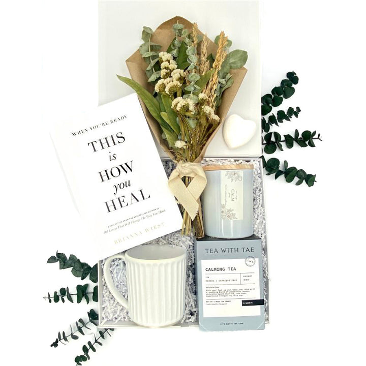 Healing Wishes Gift Box with book, bouquet, tea, candle, mug, wooden heart, and gift tag.
