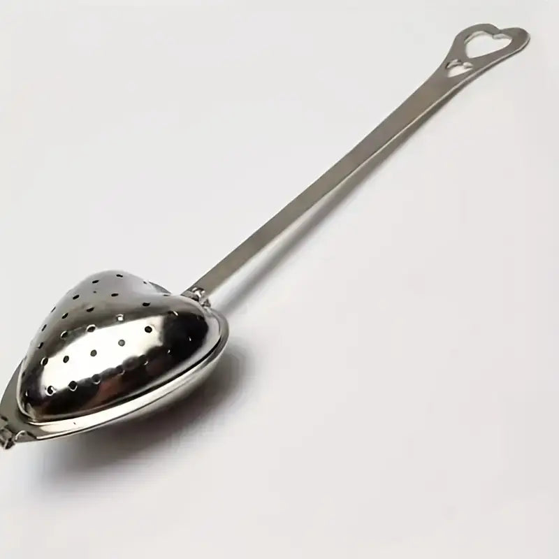 Close-up of stainless steel heart-shaped tea infuser showcasing durable craftsmanship.