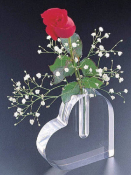 A clear acrylic heart-shaped bud vase holding a single rose, showcasing its elegant design.