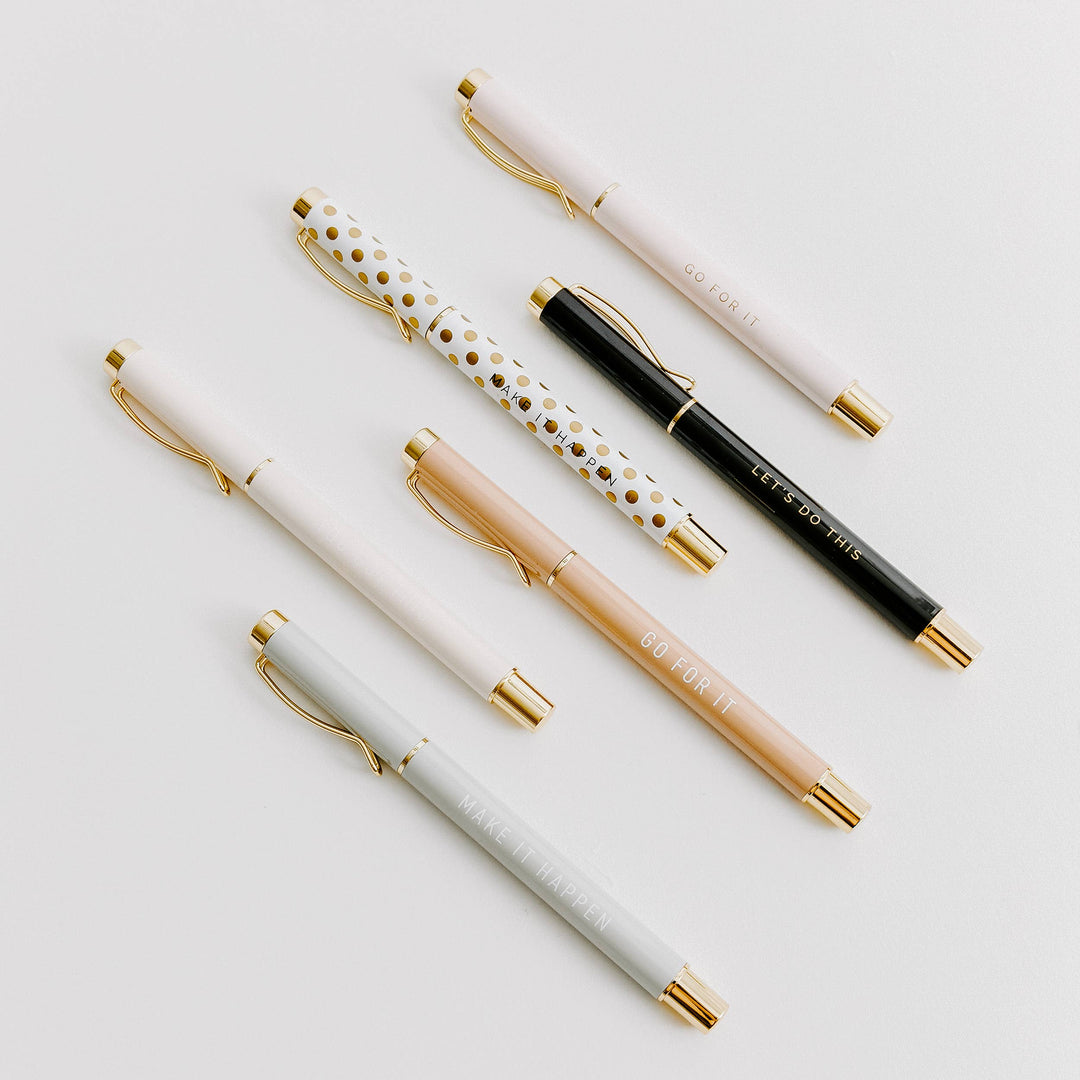 Close-up of inspirational pens displaying motivational phrases "Go For It," "Let's Do This," and "Make It Happen."