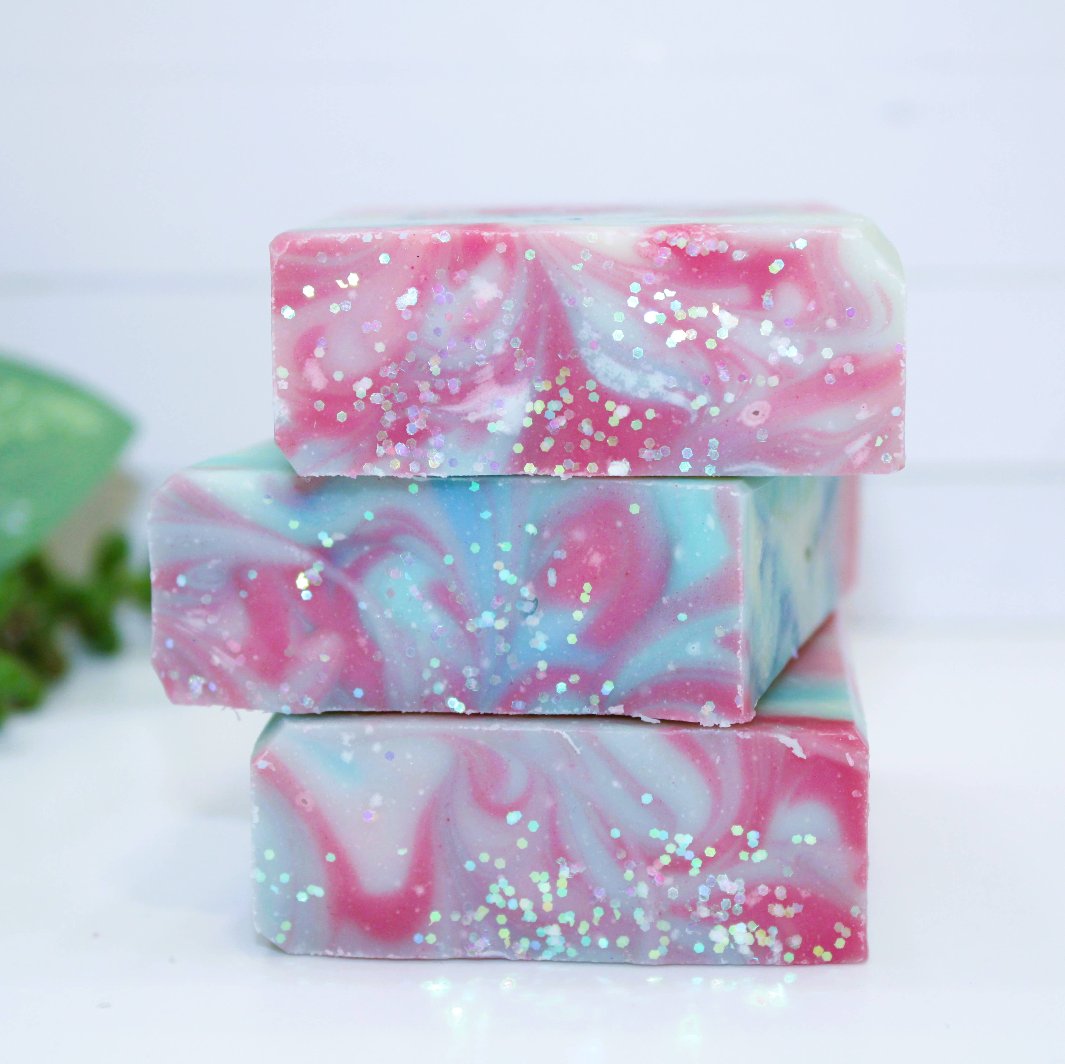 Three Mermaid Cove Soap Bars arranged together, highlighting the unique natural color patterns and glitter details.