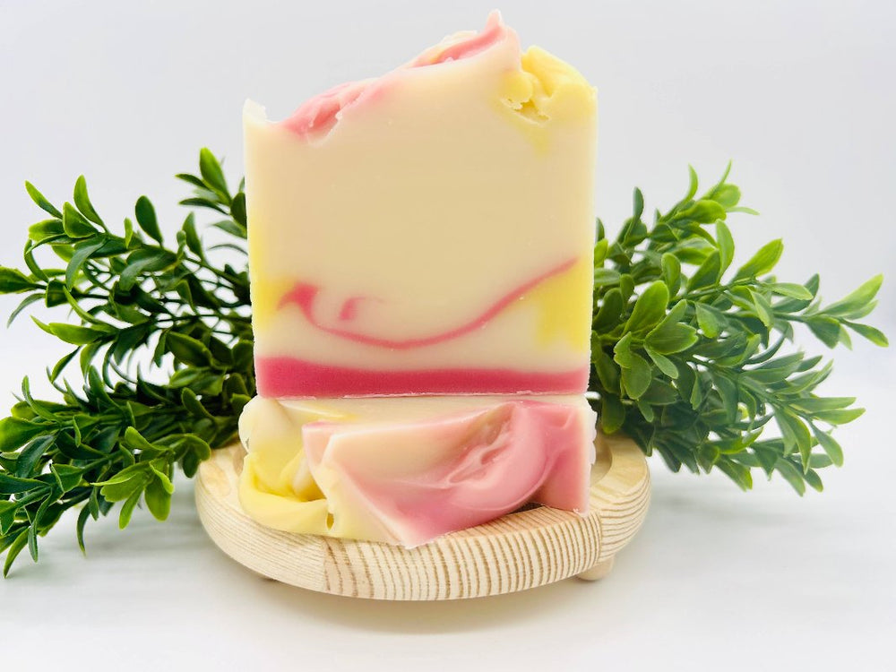 Plumeria Blooms Handmade Soap Bar showcasing its vibrant pink and yellow design.