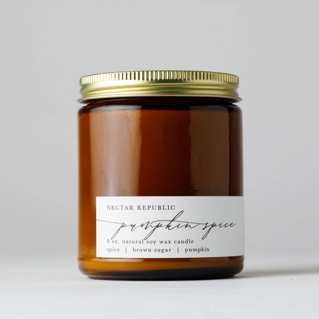 Pumpkin Spice Soy Candle by Nectar Republic in an amber apothecary jar with a gold steel lid, featuring warm notes of nutmeg, brown sugar, pumpkin and cinnamon.