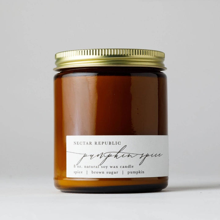 Pumpkin Spice Soy Candle by Nectar Republic in an amber apothecary jar with a gold steel lid, featuring warm notes of nutmeg, brown sugar, pumpkin and cinnamon.