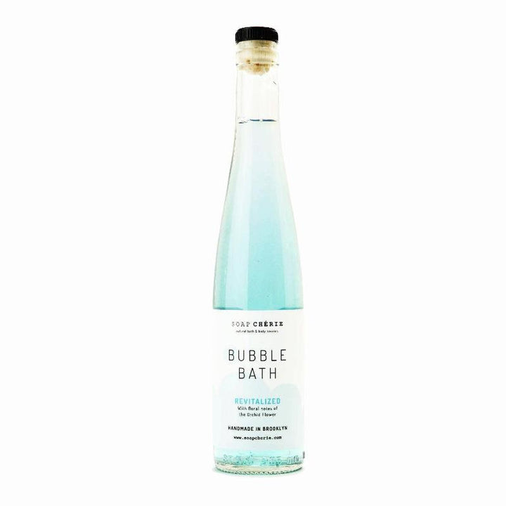 Orchid-scented turquoise bubble bath bottle, enriched with jojoba oil and vitamin E, perfect for luxurious at-home spa experiences and gifts for bath lovers.