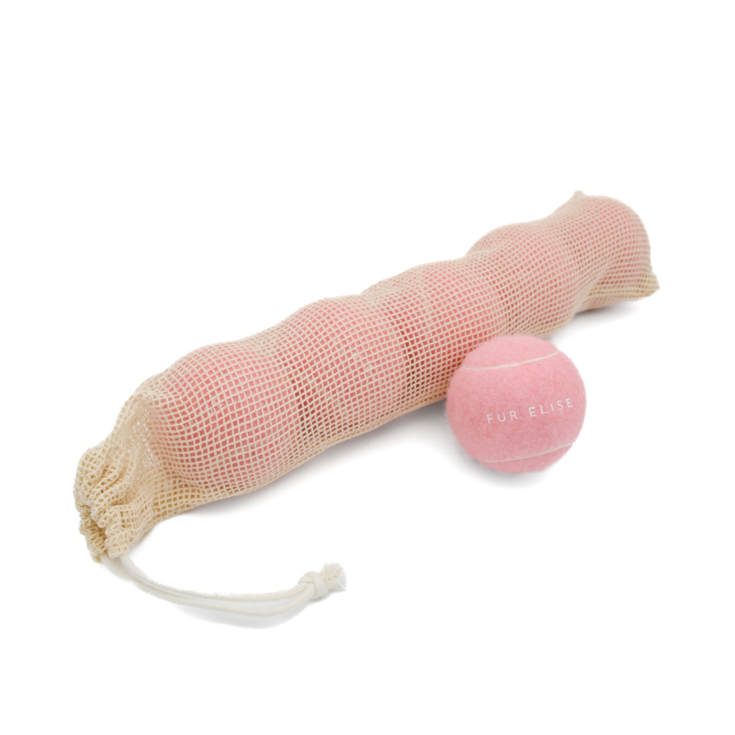 Set of 5 rose colored tennis balls for dogs in mesh drawstring pouch.
