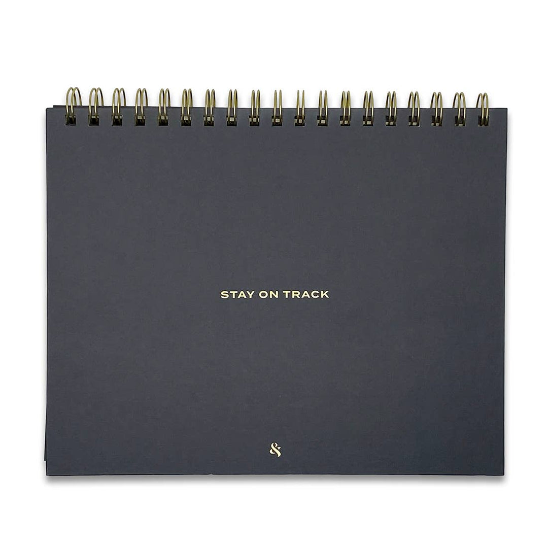 Cover Image showing the sturdy double coil spiral binding and textured hardcover with gold lettering that states "Stay On Track".