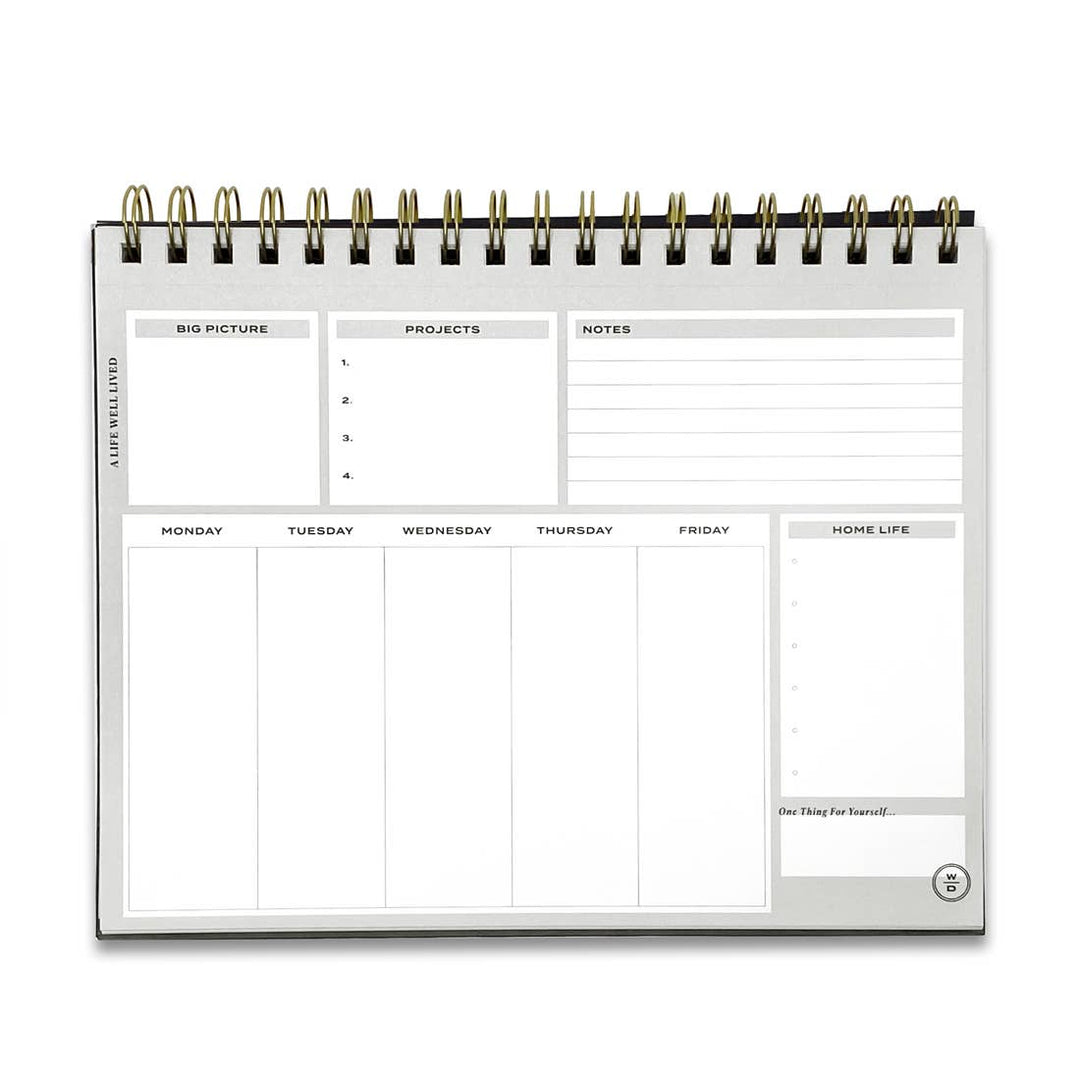 Stay on Track Notepad opened flat, displaying the structured weekly layout with space for daily tasks, projects, notes and goals.