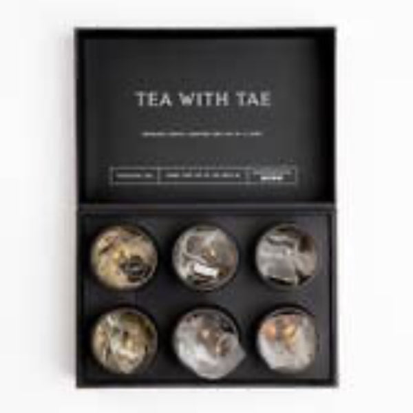 Close-up of premium tea pyramid sachets in stylish mini tea tubes from Spa Collection Tea Bento Box.
