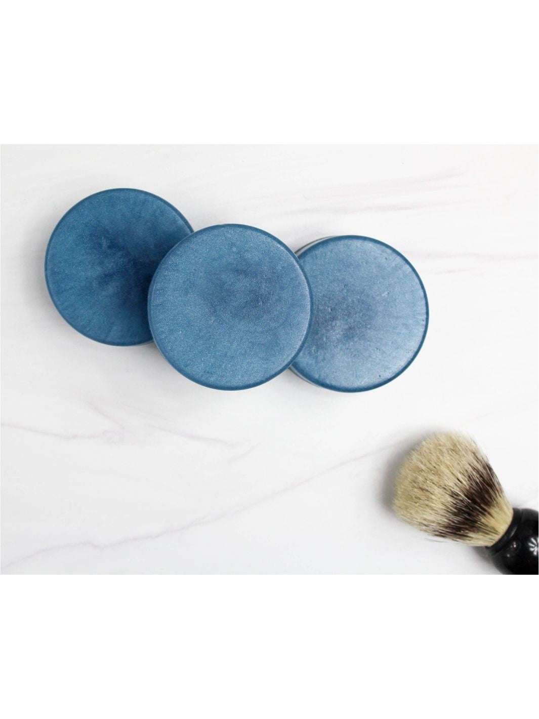 The Perfect Man Shave Soap on a marble countertop, showcasing its hand-cut craftsmanship.