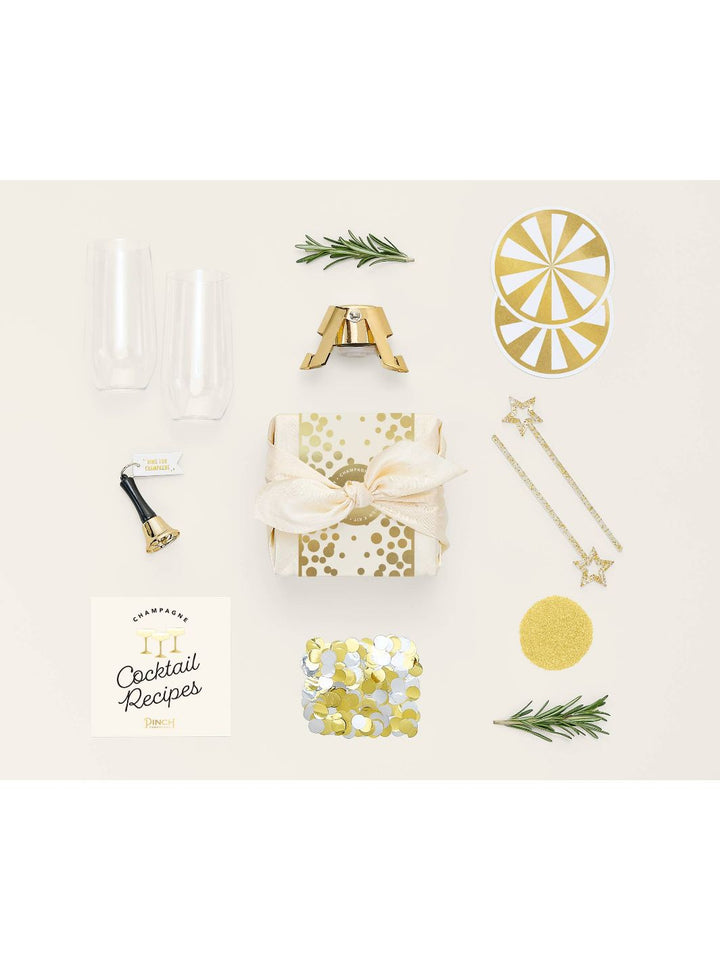 Kit contents: mini stemless champagne glasses, bottle stopper, edible glitter, and more.