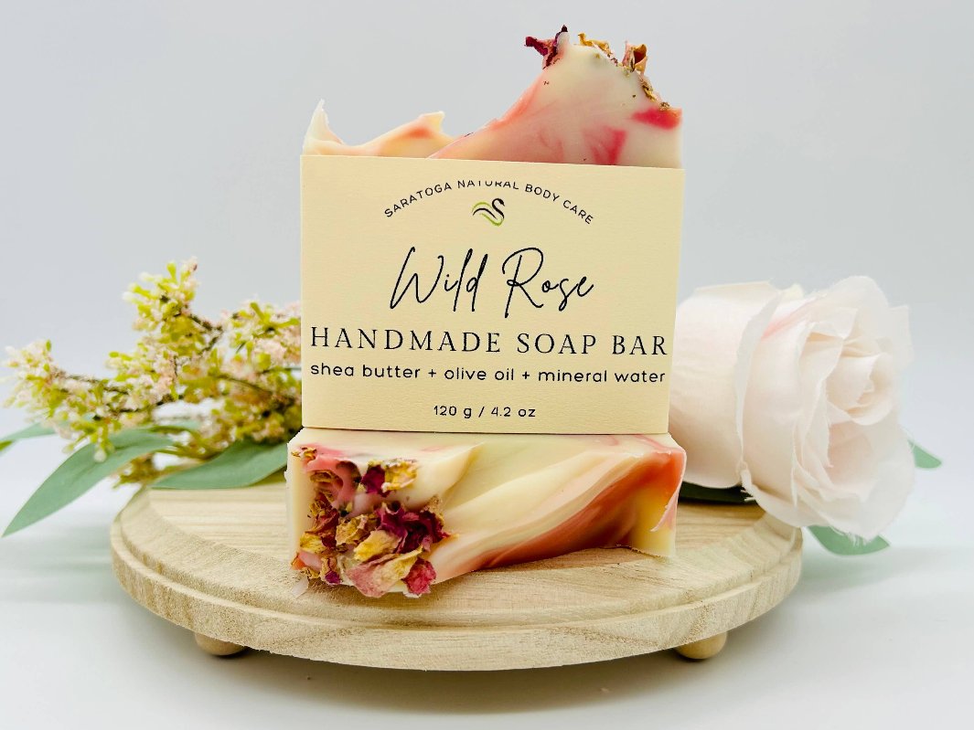 Wild Rose Handmade Soap bars styled with flowers and eco-friendly packaging.